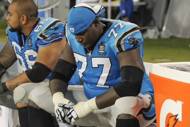 Carolina Panthers tackle Byron Bell (77) and Amini Silatolu sit on the bench near the end of an NFL football game against the Pittsburgh Steelers in Charlotte, NC, Sunday, Sept. 21, 2014. (AP Photo/Mike McCarn)