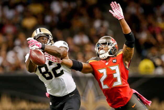 Oct 5, 2014; New Orleans, LA, USA; Tampa Bay Buccaneers strong safety Mark Barron (23) breaks up a pass to New Orleans Saints tight end Benjamin Watson (82) during the fourth quarter of a game at Mercedes-Benz Superdome. The Saints defeated the Buccaneers 37-31 in overtime. Mandatory Credit: Derick E. Hingle-USA TODAY Sports