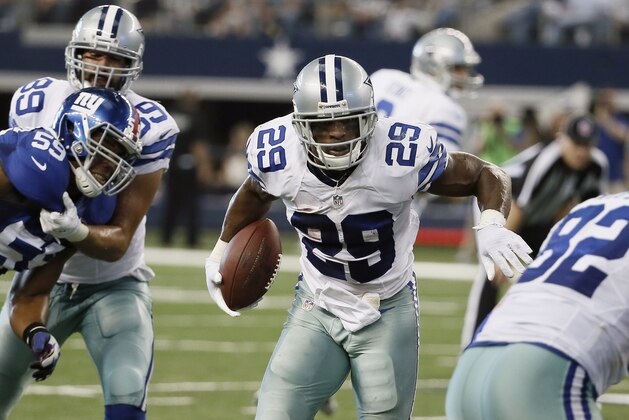 Dallas Cowboys running back DeMarco Murray (29) looks for room against the New York Giants defense during the first half of an NFL football game, Sunday, Oct.  19, 2014, in Arlington, Texas. (AP Photo/Brandon Wade)