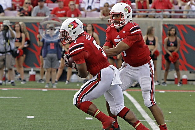 Louisville running back Michael Dyer (5) gets the football from quarterback Reggie Bonnafon (7) on this handoff in their NCAA college football game against Wake Forest in Louisville, Ky., Saturday, Sept. 27, 2014. (AP Photo/Garry Jones)