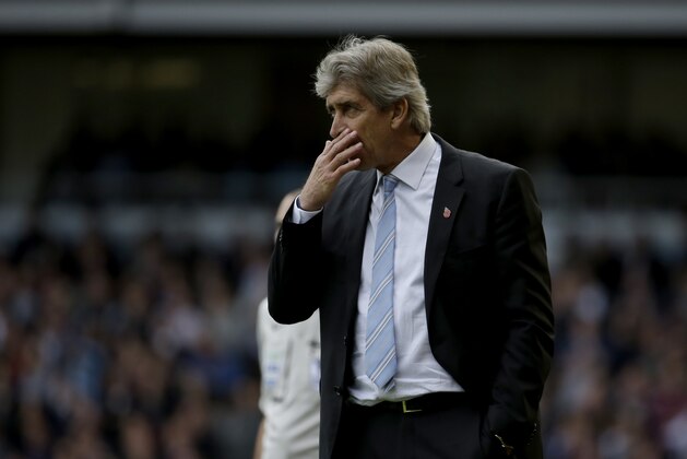 Manchester City's manager Manuel Pellegrini holds his hand up to his face during the English Premier League soccer match between West Ham and Manchester City at Upton Park stadium in London, Saturday, Oct. 25, 2014. (AP Photo/Matt Dunham)