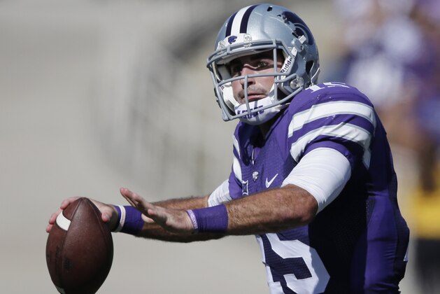 Kansas State quarterback Jake Waters (15) looks for a receiver while scrambling from the pocket during the second half of an NCAA college football game against Texas in Manhattan, Kan., Saturday, Oct. 25, 2014. Waters threw for 224 yards in the game. Kansas State defeated Texas 23-0. (AP Photo/Orlin Wagner)