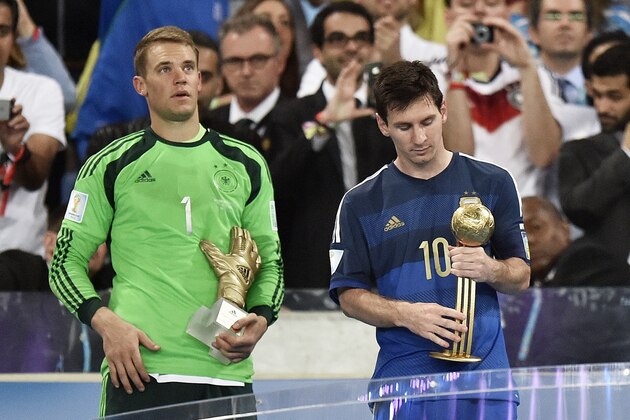 Germany's goalkeeper Manuel Neuer, left, winner of the Golden Glove award for best goalkeeper, stands with Argentina's Lionel Messi, right, winner of the Golden Ball award as the tournament's top player, after the World Cup final soccer match between Germany and Argentina at the Maracana Stadium in Rio de Janeiro, Brazil, Sunday, July 13, 2014. Germany won the match 1-0. (AP Photo/Martin Meissner)