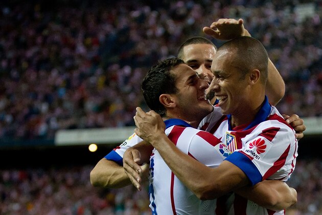 MADRID, SPAIN - AUGUST 30:  Joao Miranda (R) of Atletico de Madrid celebrates scoring their opening goal with teammates Mario Suarez (2ndR) and Koke (L) during the La Liga match between Club Atletico de Madrid and SD Eibar at Vicente Calderon Stadium on August 30, 2014 in Madrid, Spain.  (Photo by Gonzalo Arroyo Moreno/Getty Images)