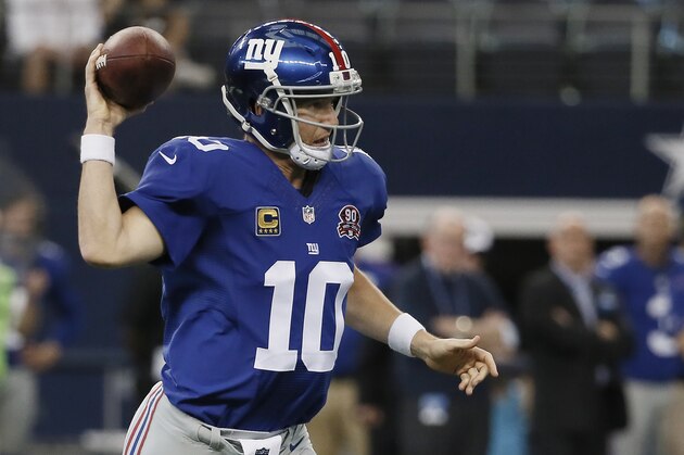New York Giants quarterback Eli Manning (10) throws to a receiver during the second half of an NFL football game against the Dallas Cowboys, Sunday, Oct.  19, 2014, in Arlington, Texas. (AP Photo/Brandon Wade)