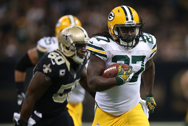 NEW ORLEANS, LA - OCTOBER 26:  Eddie Lacy #27 of the Green Bay Packers runs the ball as Curtis Lofton #50 of the New Orleans Saints defends during the first quarter at Mercedes-Benz Superdome on October 26, 2014 in New Orleans, Louisiana.  (Photo by Chris Graythen/Getty Images)