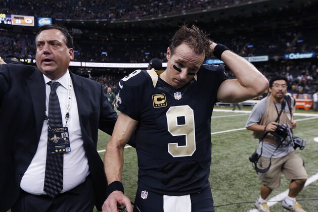 New Orleans Saints quarterback Drew Brees (9) walks off the field after an NFL football game  against the Green Bay Packers in New Orleans, Sunday, Oct. 26, 2014. (AP Photo/Rogelio Solis)