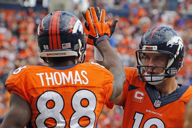 Denver Broncos quarterback Peyton Manning (18) and Demaryius Thomas (88) celebrates a touchdown during an NFL football game between the Denver Broncos and the Kansas City Chiefs, Sunday, Sept. 14, 2014, in Denver. (AP Photo/Jack Dempsey)