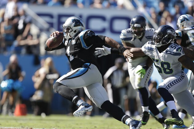 Carolina Panthers quarterback Cam Newton (1) leaves the [pocket rapidly under pressure from from Seattle Seahawks linebacker Kevin Pierre-Louis (58) during the second half of an NFL football game, Sunday, Oct. 26, 2014, in Charlotte. Newton through an interception on the play. (AP Photo/Bob Leverone)