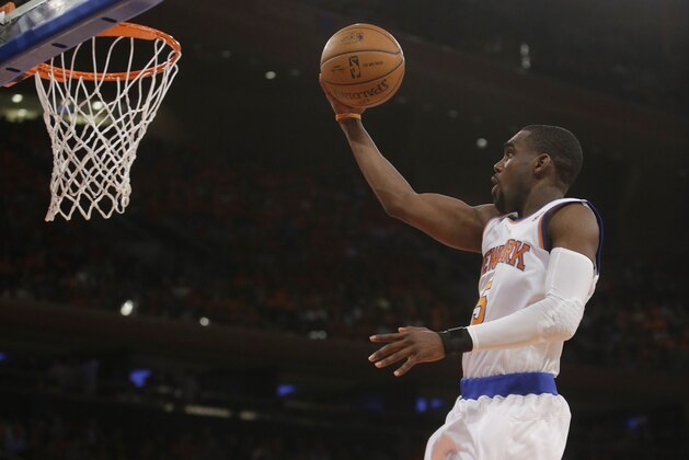 New York Knicks' Tim Hardaway Jr. (5) drives past Brooklyn Nets' Alan Anderson (6) during the first half of an NBA basketball game Wednesday, April 2, 2014, in New York.  (AP Photo/Frank Franklin II)