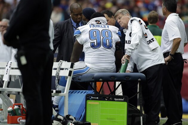 Detroit Lions trainers check on defensive tackle Nick Fairley (98) in the first half of the NFL football game against the Atlanta Falcons at Wembley Stadium, London, Sunday, Oct. 26, 2014.  (AP Photo/Matt Dunham)