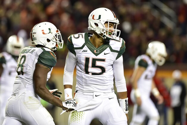 Oct 23, 2014; Blacksburg, VA, USA; Miami Hurricanes running back Duke Johnson (8) celebrates with quarterback Brad Kaaya (15) after running for a touchdown in the last few seconds of the second quarter at Lane Stadium. Mandatory Credit: Bob Donnan-USA TODAY Sports