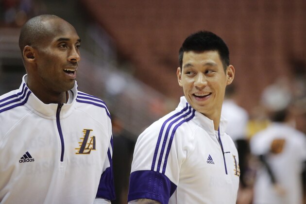 Los Angeles Lakers' Jeremy Lin smiles whilte talking to Kobe Bryant before a preseason NBA basketball game against the Phoenix Suns on Tuesday, Oct. 21, 2014, in Anaheim, Calif. (AP Photo/Jae C. Hong)