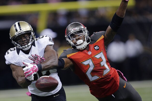Tampa Bay Buccaneers strong safety Mark Barron (23) breaks up a pass intended for New Orleans Saints tight end Benjamin Watson (82) in the second half of an NFL football game in New Orleans, Sunday, Oct. 5, 2014. The Saints won 37-31. (AP Photo/Bill Haber)