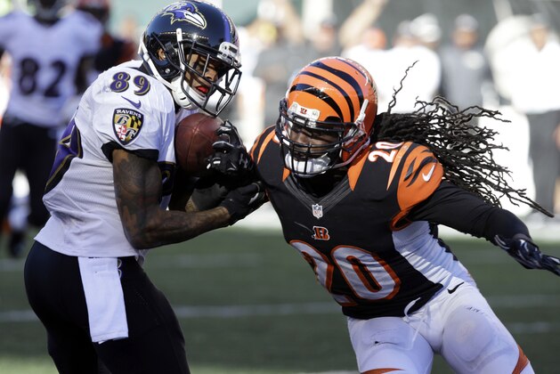 Baltimore Ravens wide receiver Steve Smith, left, breaks the tackle of Cincinnati Bengals free safety Reggie Nelson on a last minute catch during the second half of an NFL football game in Cincinnati, Sunday, Oct. 26, 2014. Offensive interference was called on the play. (AP Photo/Al Behrman)