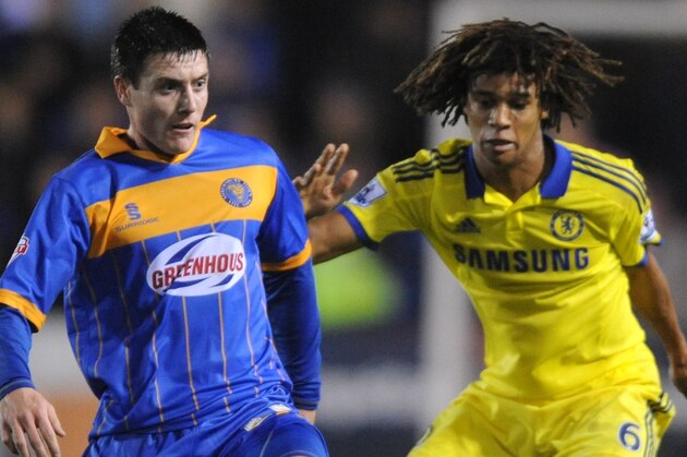 Shrewsbury's Bobby Grant, left, holds back Chelsea's Nathan Ake, during the Fourth Round of the English League Cup soccer match between Shrewsbury Town and Chelsea at Greenhous Meadow, Shrewsbury, England, Tuesday, Oct. 28, 2014. (AP Photo/Rui Vieira)