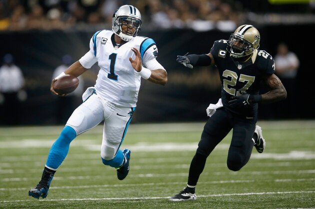 NEW ORLEANS, LA - DECEMBER 08:  Quarterback Cam Newton #1 of the Carolina Panthers runs to escape the defense of  Malcolm Jenkins #27 of the New Orleans Saints during the first quarter at Mercedes-Benz Superdome on December 8, 2013 in New Orleans, Louisiana.  (Photo by Chris Graythen/Getty Images)