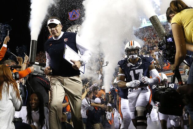 Auburn head coach Gus Malzahn runs onto the field before the first half of an NCAA college football game against South Carolina on Saturday, Oct. 25, 2014, in Auburn, Ala. (AP Photo/Butch Dill)