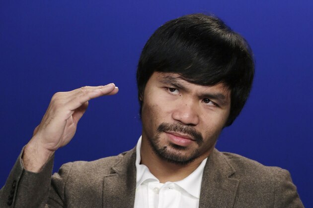 Boxer Manny Pacquiao gestures during an interview with The Associated Press, Friday, Sept. 5, 2014 in New York. Pacquiao takes on undefeated Chris Algieri in the gambling enclave of Macau on Nov. 22 for a piece of the welterweight title. The bout comes a year after the Filipino headlined the first big fight card there by beating Brandon Rios. (AP Photo/Mark Lennihan)