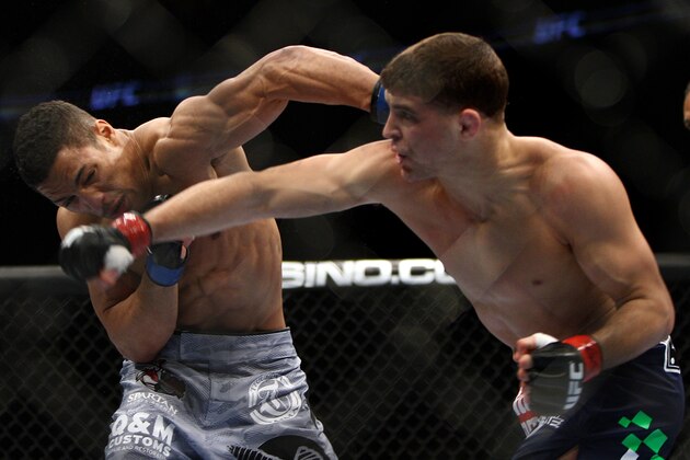 Al Iaquinta, right, and Kevin Lee exchange blows during the first round of a UFC 169 lightweight mixed martial arts bout in Newark, N.J., Saturday, Feb. 1, 2014. Iaquinta won by unanimous decision. (AP Photo/Tim Larsen)