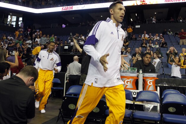 Los Angeles Lakers guard Steve Nash runs out onto the court for a preseason NBA basketball game against the Golden State Warriors, Sunday, Oct. 12, 2014, in Ontario, Calif. (AP Photo/Alex Gallardo)