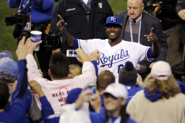 Kansas City Royals' Lorenzo Cain celebrates with fans after Game 6 of baseball's World Series against the San Francisco Giants Tuesday, Oct. 28, 2014, in Kansas City, Mo. The Royals won 10-0 to tie the series at 3-3. (AP Photo/Jeff Roberson)