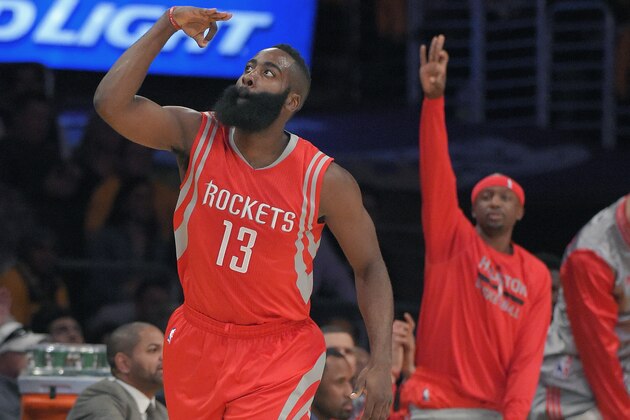 Houston Rockets guard James Harden, left, gestures after hitting a three point shot during the first half of an NBA basketball game against the Los Angeles Lakers, Tuesday, Oct. 28, 2014, in Los Angeles. (AP Photo/Mark J. Terrill)