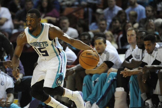 Charlotte Hornets guard Kemba Walker (15) looks to score against the Washington Wizards during the first half of a preseason NBA basketball game, Friday, Oct. 10, 2014, in Greenville, S.C. Charlotte won 99-86. (AP Photo/Rainier Ehrhardt)