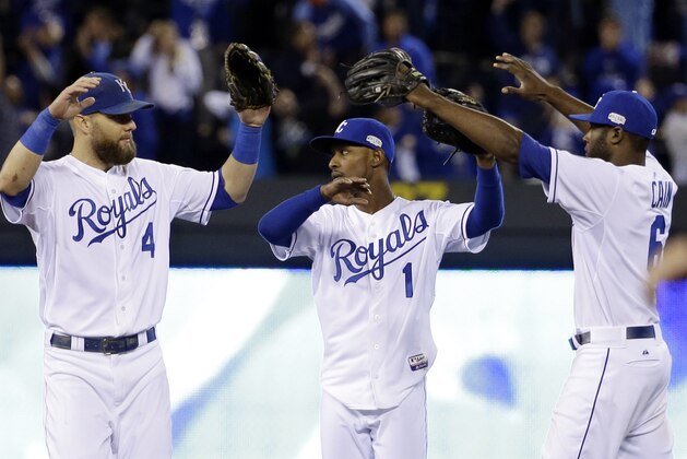 Kansas City Royals' Alex Gordon (4), Jarrod Dyson (1) and Lorenzo Cain (6) celebrate after Game 6 of baseball's World Series against the San Francisco Giants Tuesday, Oct. 28, 2014, in Kansas City, Mo. The Royals won 10-0 to tie the series at 3-3.  (AP Photo/David J. Phillip)
