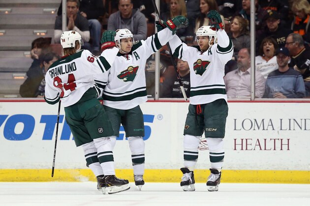 ANAHEIM, CA - JANUARY 28:  (L-R) Mikael Granlund #64, Zach Parise #11 and Jason Pominville #29 of the Minnesota Wild celebrate Pominville's first period goal against the Anaheim Ducks at Honda Center on January 28, 2014 in Anaheim, California.  (Photo by Jeff Gross/Getty Images)