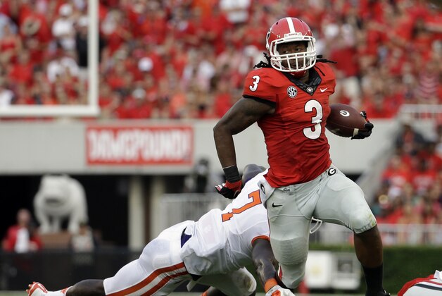 Georgia's Todd Gurley, right, runs past the reach of Clemson's Tony Steward in the first half of an NCAA college football game, Saturday, Aug. 30, 2014, in Athens, Ga. Georgia won 45-21. (AP Photo/David Goldman)