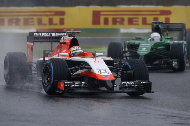 Marussia driver Jules Bianchi of France leads Caterham driver Kamui Kobayashi of Japan during the Japanese Formula One Grand Prix at the Suzuka Circuit in Suzuka, central Japan, Sunday, Oct. 5, 2014. Bianchi has been taken to hospital and is unconscious following a crash during the race. (AP Photo/Toru Takahashi)