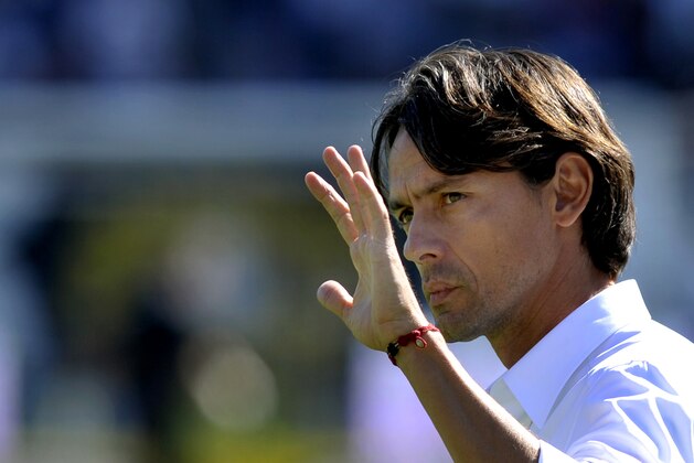 AC Milan coach Filippo Inzaghi waves to supporters before a Serie A soccer match between Cesena and AC Milan at Cesena's Manuzzi stadium, Italy, Sunday, Sept. 28, 2014. (AP Photo/Marco Vasini)