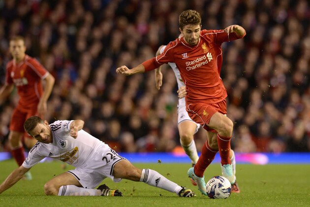 LIVERPOOL, ENGLAND - OCTOBER 28:  Fabio Borini of Liverpool is tackled by Angel Rangel of Swansea during the Capital One Cup Fourth Round match between Liverpool and Swansea City at Anfield on October 28, 2014 in Liverpool, England.  (Photo by Gareth Copley/Getty Images)