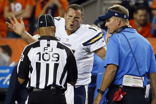 San Diego Chargers quarterback Philip Rivers argues with field judge Dyrol Prioleau (109) as San Diego Chargers head coach Mike McCoy looks on during the second half of an NFL football game, Thursday, Oct. 23, 2014, in Denver. (AP Photo/Jack Dempsey)