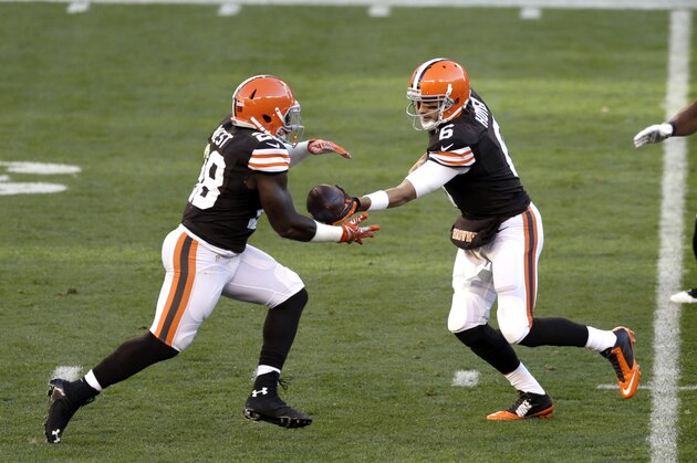 Cleveland Browns quarterback Brian Hoyer, right, hands the ball off to running back Terrance West during an NFL football game between the Oakland Raiders and Cleveland Browns Sunday, Oct. 26, 2014, in Cleveland. (AP Photo/Tony Dejak)
