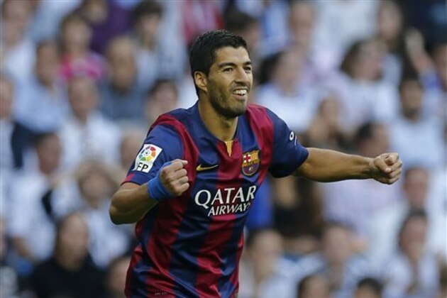 CORRECTING PLAYER WHO SCORED TO NEYMAR - Barcelona's Luis Suarez celebrates after Barcelona teammate Neymar scored during a Spanish La Liga soccer match between Real Madrid and Barcelona at the Santiago Bernabeu stadium in Madrid, Spain, Saturday Oct. 25, 2014. (AP Photo/Paul White)