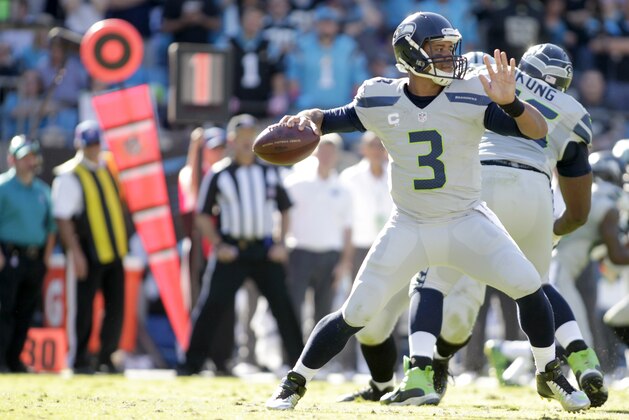 Seattle Seahawks' Russell Wilson (3) aims a pass against the Carolina Panthers during the second half of an NFL football game Sunday, Oct. 26, 2014, in Charlotte, N.C. The Seahawks won 13-9. (AP Photo/Bob Leverone)