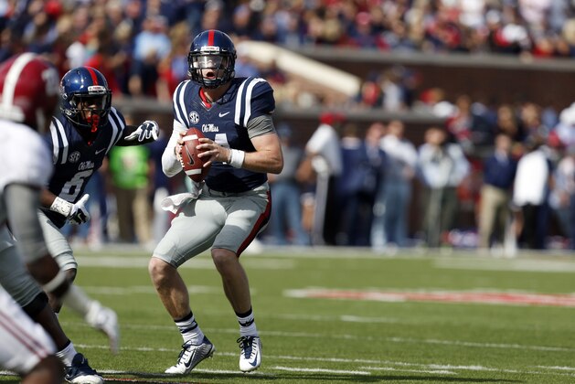 Mississippi quarterback Bo Wallace (14) sets up to pass against Alabama in the first half of an NCAA college football game in Oxford, Miss., Saturday, Oct. 4, 2014. No. 11 Mississippi won 23-17. (AP Photo/Rogelio V. Solis)