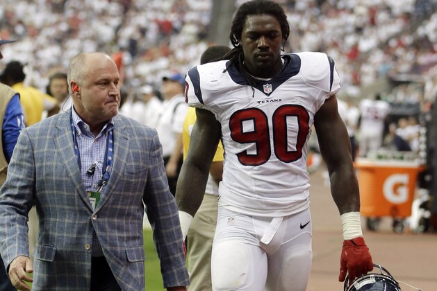 Houston Texans' Jadeveon Clowney (90) leaves with a knee injury during the second quarter of an NFL football game against the Washington Redskins, Sunday, Sept. 7, 2014, in Houston. (AP Photo/Patric Schneider)
