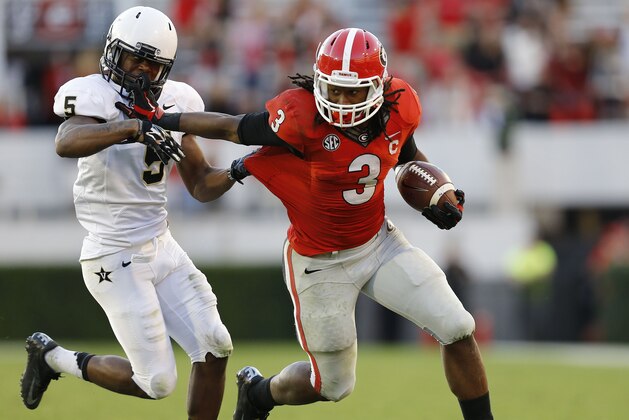 ATHENS, GA - OCTOBER 04:  Running back Todd Gurley #3 of the Georgia Bulldogs stiff arms cornerback Torren McGaster #5 of the Vanderbilt Commodores during a running play in the game at Sanford Stadium on October 4, 2014 in Athens, Georgia.  (Photo by Mike Zarrilli/Getty Images)