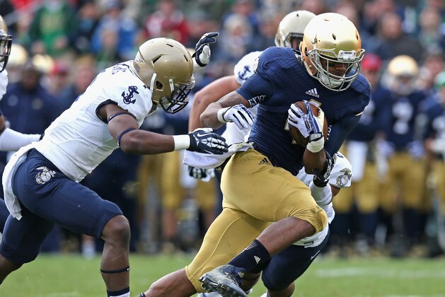 SOUTH BEND, IN - NOVEMBER 02:  George Atkinson III #4 of the Notre Dame Fighting Irish breaks away from Brandon Clements #1 of the Navy Midshipmen to score a touchdown at Notre Dame Stadium on November 2, 2013 in South Bend, Indiana. Notre Dame defeated Navy 38-34.  (Photo by Jonathan Daniel/Getty Images)