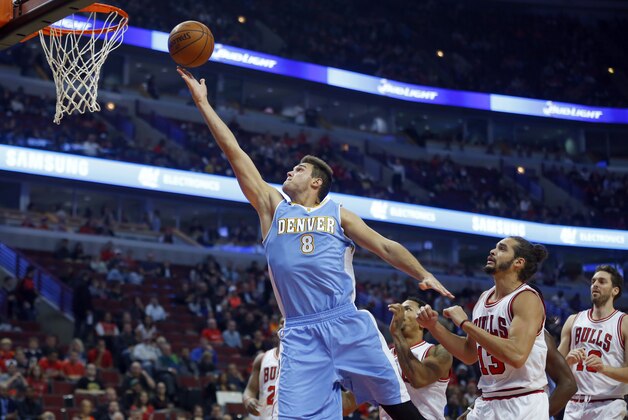 Denver Nuggets forward Danilo Gallinari (8) goes in for a lay-up past Chicago Bulls center Joakim Noah (13) during the first half of a pre-season NBA basketball game in Chicago, on Monday Oct. 13, 2014. (AP Photo/Jeff Haynes)