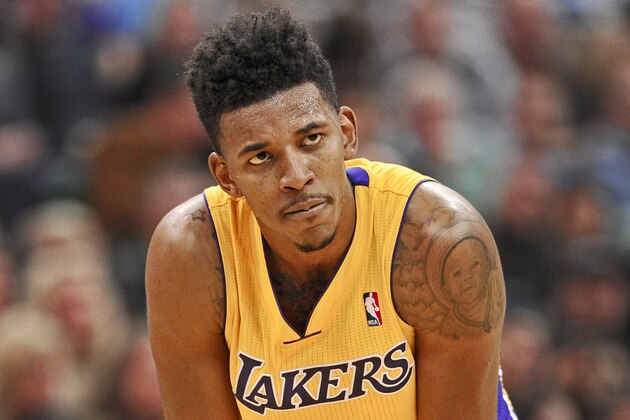 Los Angeles Lakers' Nick Young (0) stares at an official  in the second half of an NBA basketball game against the Utah Jazz Friday, Dec. 27, 2013, in Salt Lake City. Jazz won 105-103. (AP Photo/Gene Sweeney Jr.)