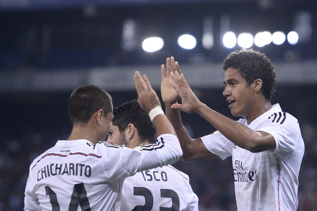 Real Madrid's Raphael Varan, right, reacts after scoring his second goal with his teammate Chicharito, left, against Cornella during a Copa del Rey soccer match in Cornella Llobregat, Spain, Wednesday, Oct. 29, 2014. (AP Photo/Manu Fernandez)