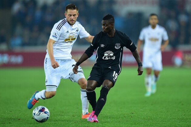 SWANSEA, WALES - SEPTEMBER 23:  Swansea player Gylfi Sigurdsson (l) challenges Christian Atsu during the Capital One Cup Third Round match between Swansea City and Everton at Liberty Stadium on September 23, 2014 in Swansea, Wales.  (Photo by Stu Forster/Getty Images)