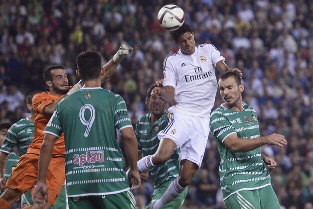 Real Madrid's Raphael Varane heads for the ball for scoring his second goal against Cornella during a Copa del Rey soccer match in Cornella Llobregat, Spain, Wednesday, Oct. 29, 2014. (AP Photo/Manu Fernandez)