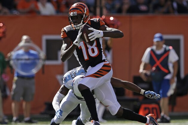 Cincinnati Bengals wide receiver A.J. Green (18) is tackled by Tennessee Titans cornerback Blidi Wreh-Wilson (25) in the second half of an NFL football game, Sunday, Sept. 21, 2014, in Cincinnati. (AP Photo/Darron Cummings)
