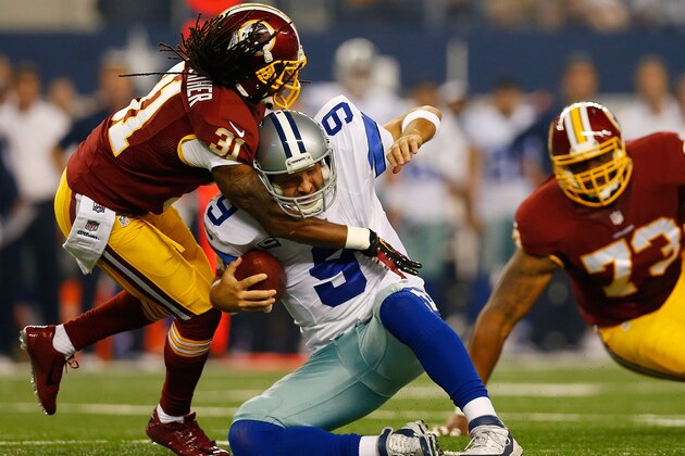 ARLINGTON, TX - OCTOBER 27:  Tony Romo #9 of the Dallas Cowboys is sacked by Brandon Meriweather #31 of the Washington Redskins during the first half at AT&T Stadium on October 27, 2014 in Arlington, Texas.  (Photo by Tom Pennington/Getty Images)