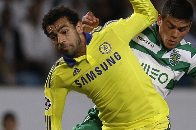 Chelsea's Mohamed Salah, foreground, is challenged by Sporting's Jonathan Silva, during a Champions League, Group G soccer match between Sporting and Chelsea, in Lisbon, Tuesday, Sept. 30, 2014. (AP Photo/Francisco Seco)